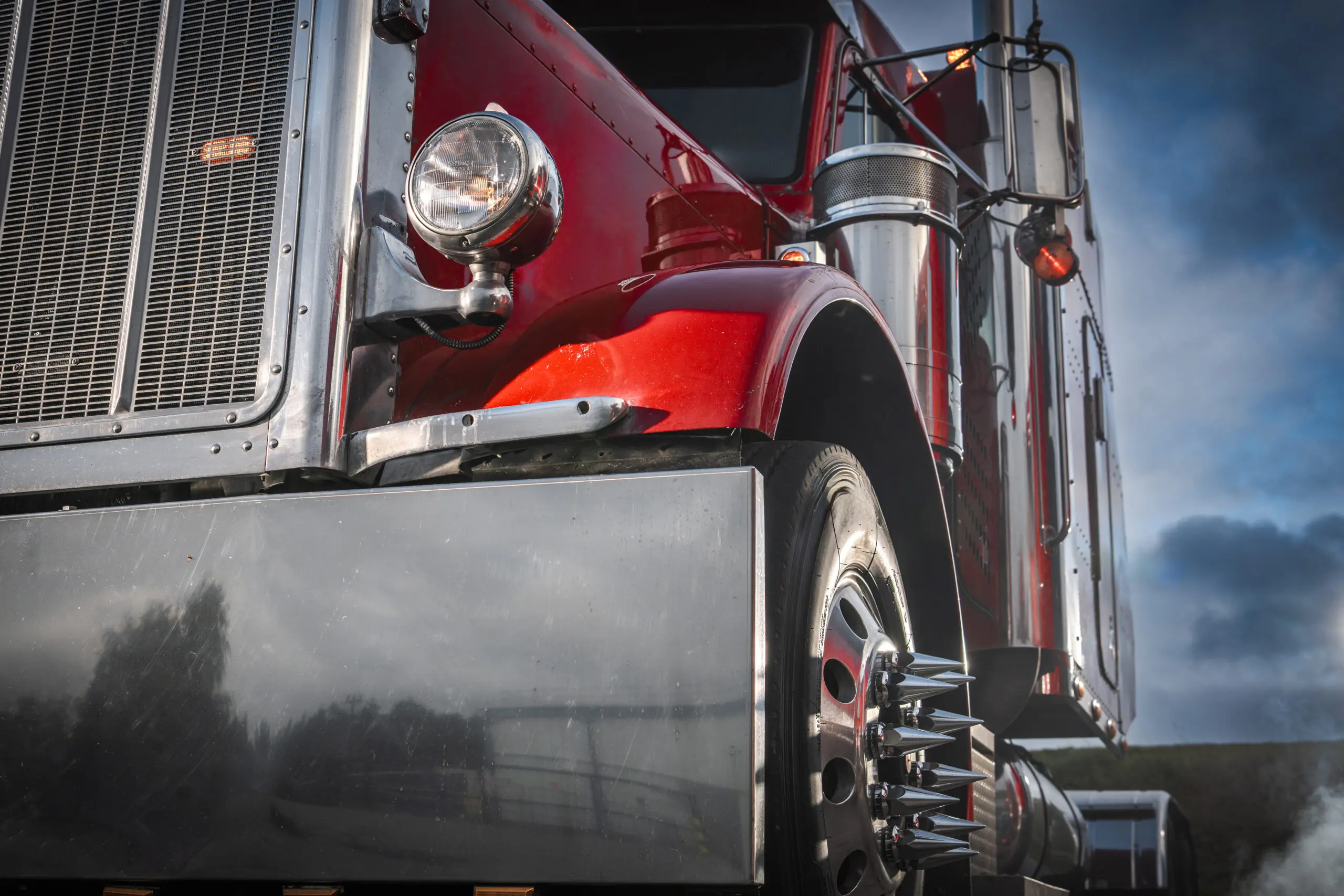 Red Semi Tractor Truck in Focus During Cloudy Evening