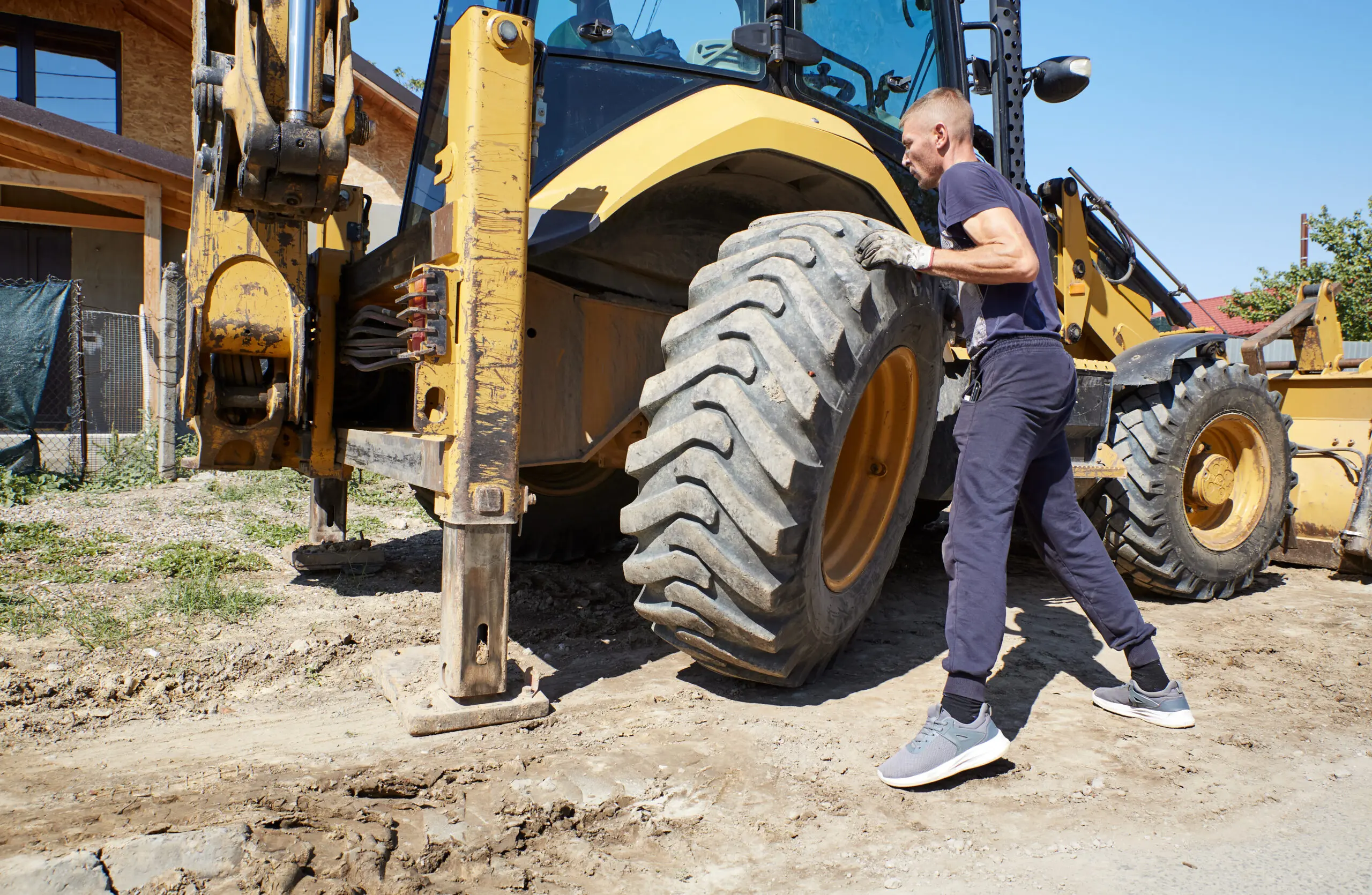 Mechanic changing tire on the bulldozer